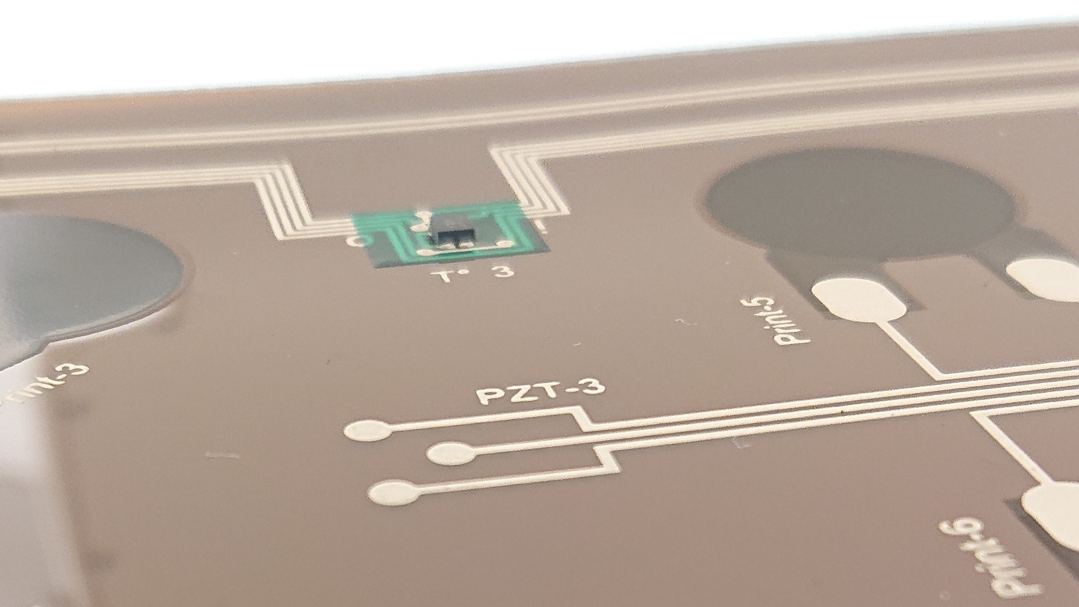 © A. Latour, CEA for SPARTACUS Details of the printed circuit board for the battery sensor system with mounted temperature sensor and printed ultrasonic sensors.